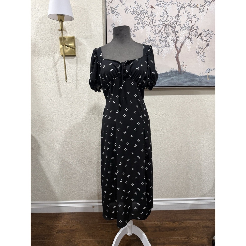 Pretty Black midi-length dress with puff sleeves and a white bow pattern.